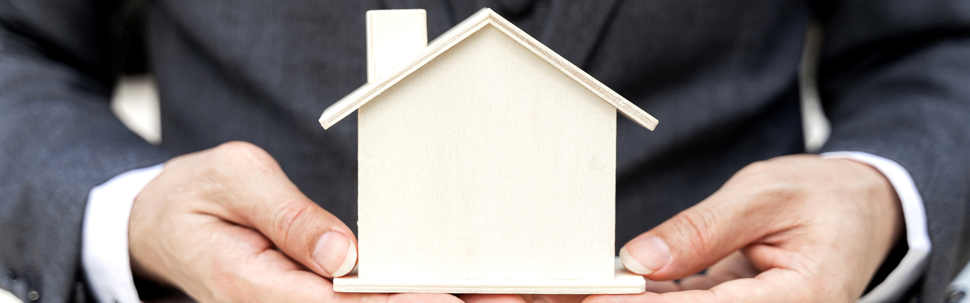 close-up-asian-business-man-holding-model-house-business-finance-concept.jpg